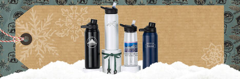 Four custom bottles sitting on a holiday themed set with a gift tag behind them.
