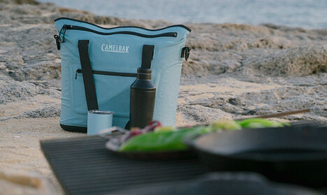 A ChillBak Tote 18 sitting on a beach campsite.
