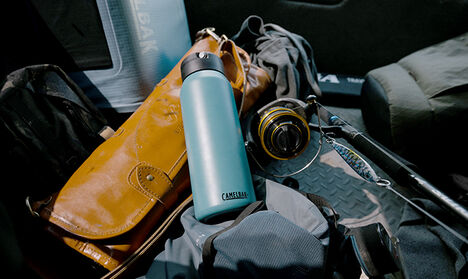 A Fit Cap water bottle laying on top of fishing gear.