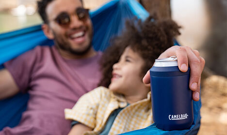 Father in a hammock with his son and a CamelBak Can Cooler