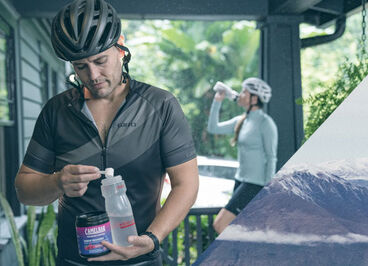 A man mixing up his BCAAs in his Podium bottle.