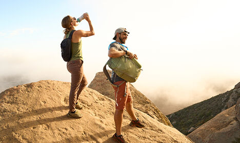 Two hikers at the top of peak.