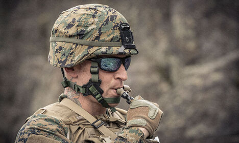 Soldier drinking from a hydration pack fitted with a Quicklink Hydrolock bite valve.