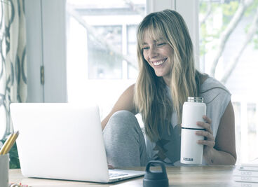 Woman sitting down on her laptop.