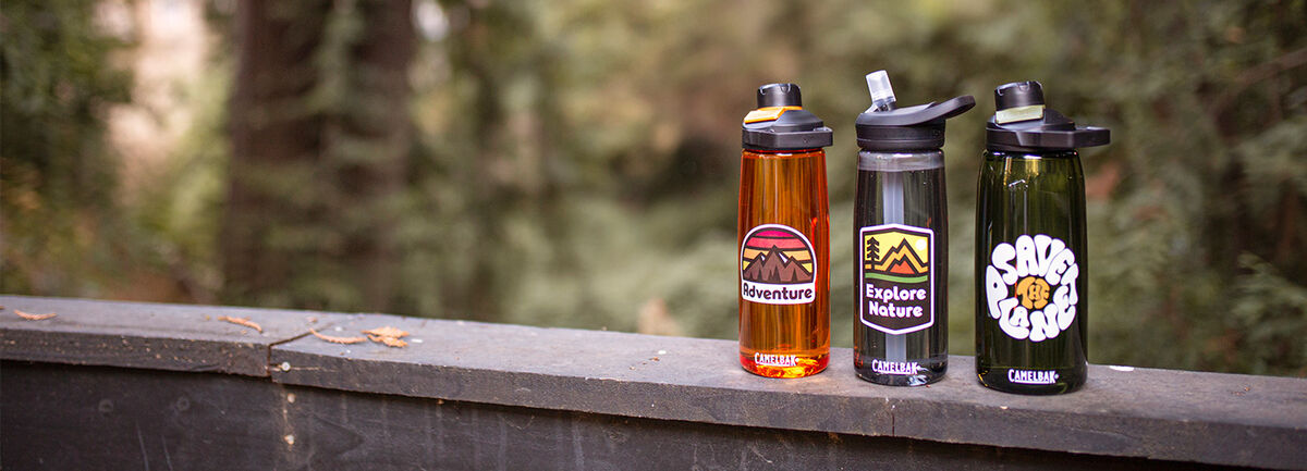 Three custom water bottles lined up on a railing. Three custom water bottles lined up on a railing.