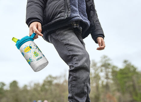 Kid carrying an eddy+ bottle. 