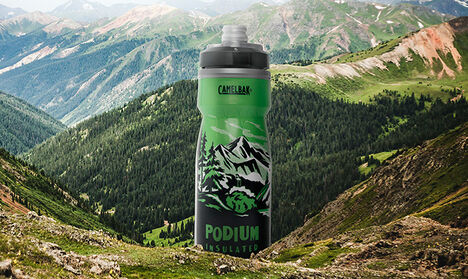 Podium Destination Series II Alpine bottle sitting in a green mountain valley.