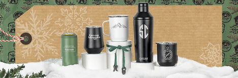 Two custom drinkware VSS tumblers on a log