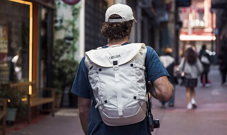  Man walking down an alley with an Adventure Travel Pack on