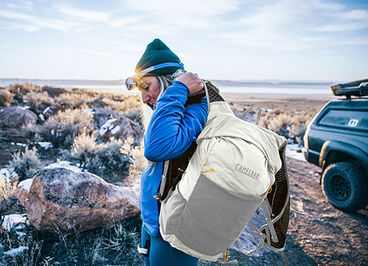 Woman gearing up with a new Octane 16 Hydration pack