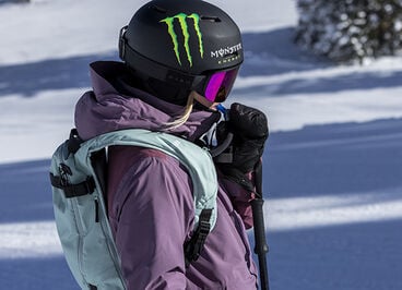 Woman drinking from her hydration pack while on the mountain.