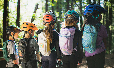 Five kids wearing mini Mule packs lined up