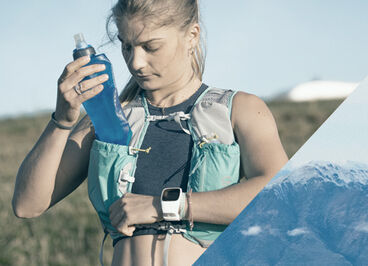 Woman taking a quick stow flask out of her hydration vest.