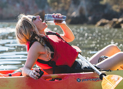 Woman drinking from her water bottle.