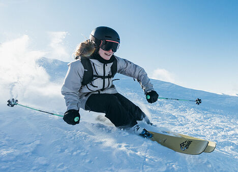 A person skiing down hill on snow. A person skiing down hill on snow.