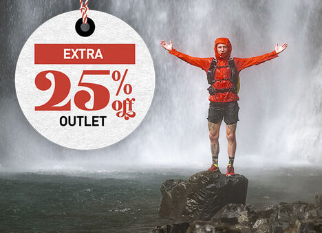 Hiker standing in front of a waterfall with text to the right which reads "Extra 25% off Outlet"