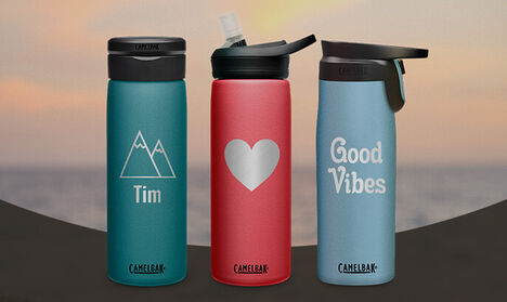 Three custom bottles with a sunset in the background