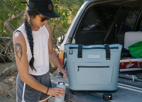 Woman filling up her water bottle with the ChillBak™ Group Reservoir