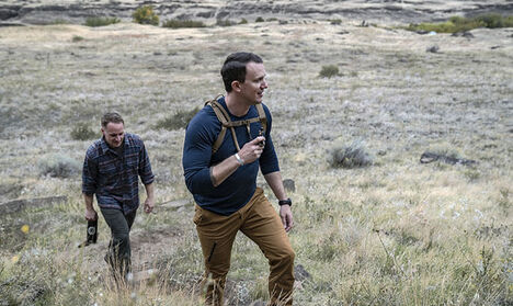 Two Men Walking Up Hill