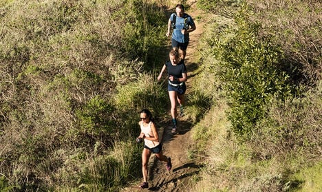 Three trail runners out in the sun