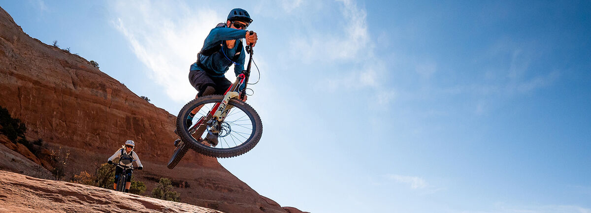 Two Mountain Bikers wearing Hydration Packs.