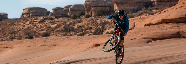 Mountain biker rides in the desert with his Camelbak Mountain biker rides in the desert with his Camelbak