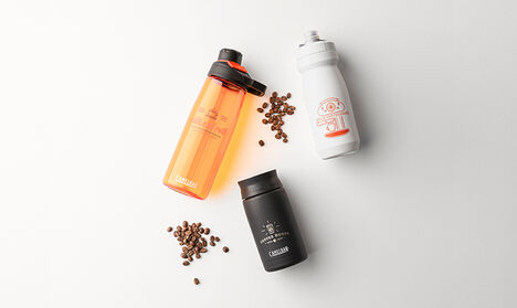 Three custom water bottles with coffee beans.