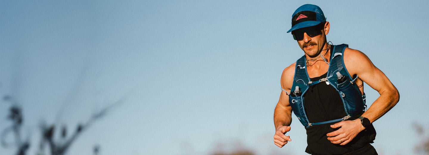 runner wearing a blue hat and a blue running vest