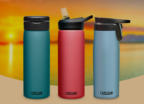 Three Baja color water bottles with a sunset in the background