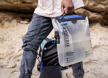 A Group Reservoir being carried by someone on a trail.