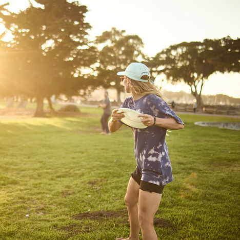 Woman throwing a frisbee on a sunny day