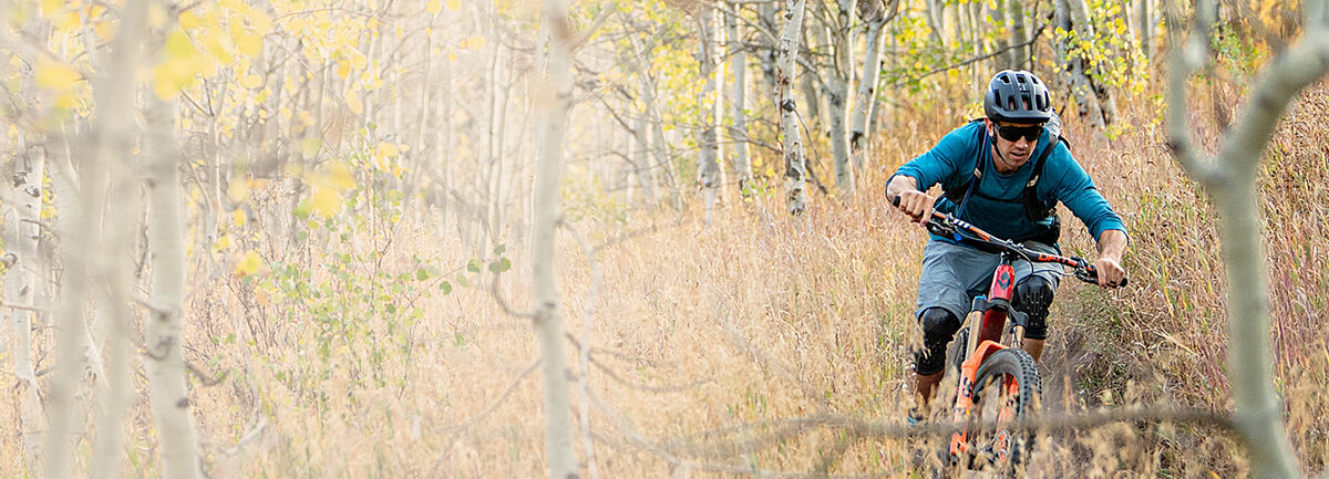 Man riding his mountain bike through a spring trail.