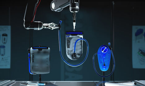 A robot filling a CamelBak reservoir with water.