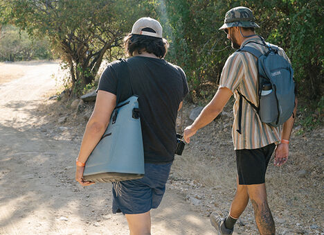 Two guys trekking down a path with a ChillBak™ over the shoulder.