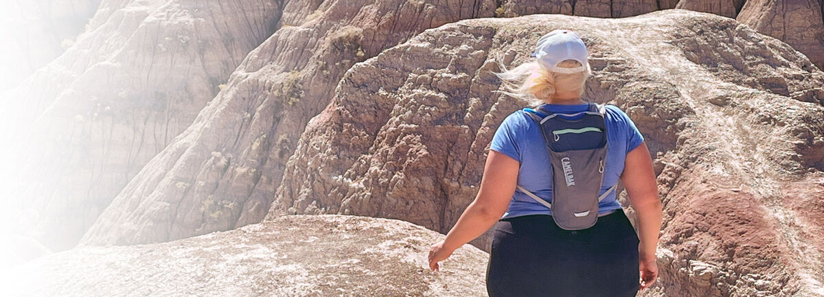 Unlikely Hikers founder Jenny Bruso out hiking wear a CamelBak. Unlikely Hikers founder Jenny Bruso out hiking wear a CamelBak.