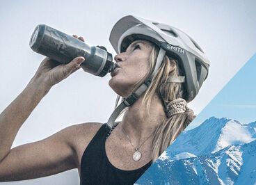 Woman drinking out of a Podium Dirt bottle.