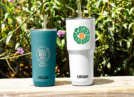 Two customized drinkware bottles with "World's Best Mom" on one and "Save the Planet" on the other.