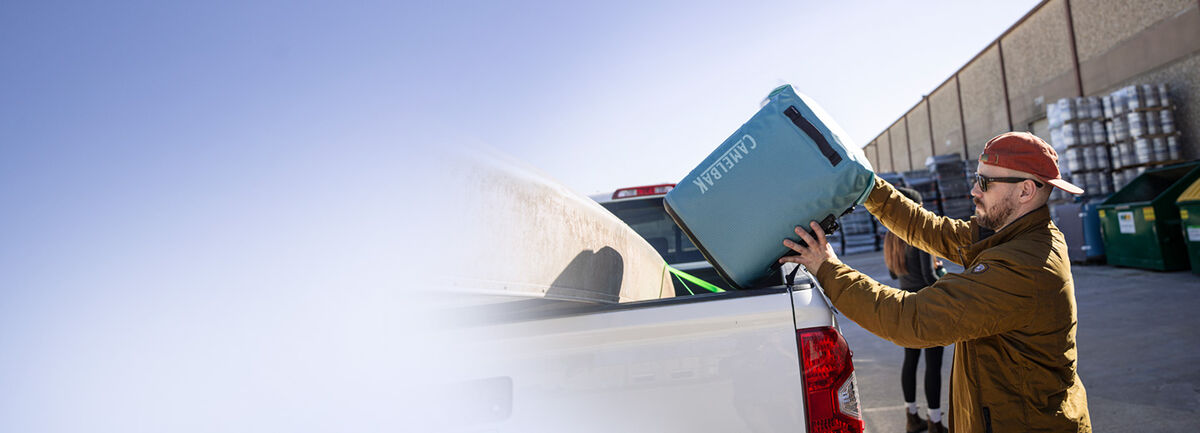 Man putting his ChillBak Cooler into his truck
