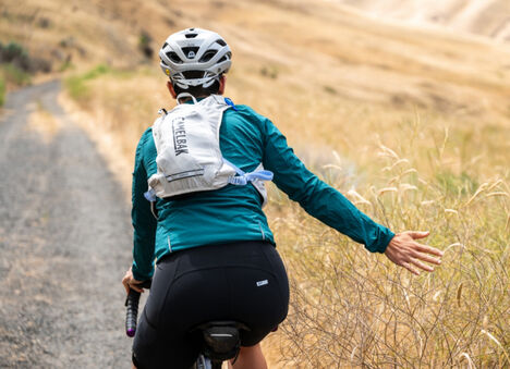 cyclist riding through a field