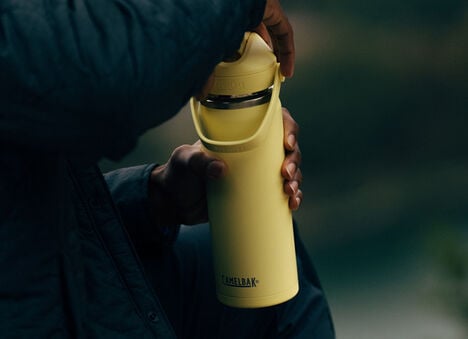 Thrive water bottle on someone's hands
