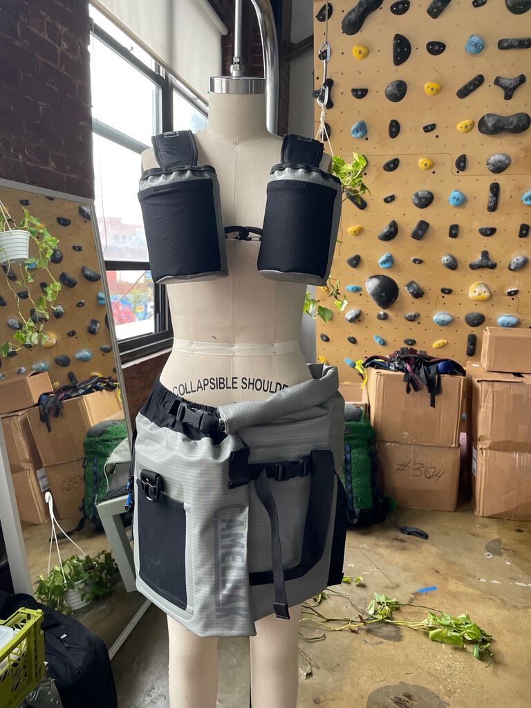 the hydro skirt on a mannequin with a climbing wall in the background.