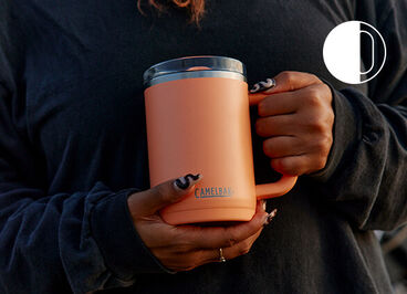 Someone holding a Thrive Mug in their left hand.