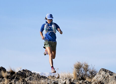 A person running wearing a hydration vest. A person running wearing a hydration vest.