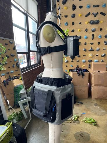 Hydro skirt on a mannequin turned to the right with a climbing wall in the background.