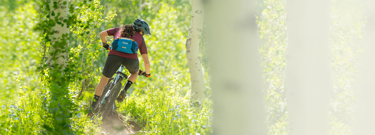 Man riding his mountain bike through a spring trail.