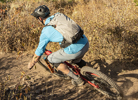 Man on mountain bike wearing a hydration backpack. Man on mountain bike wearing a hydration backpack.