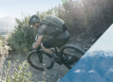 Man mountain biking down a hill.
