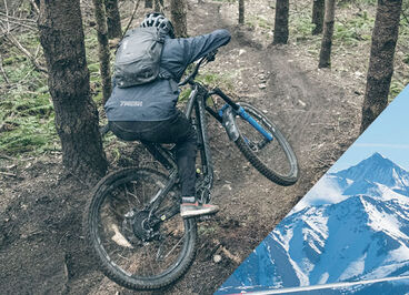 Mountain biker riding down a hill wearing his CamelBak Hydration Pack.