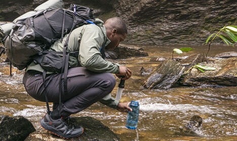 Person filling up CamelBak filtered by Lifestraw Water Bottle. Person filling up CamelBak filtered by Lifestraw Water Bottle.