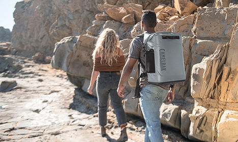 Two people hiking with a ChillBak Backpack Cooler on.